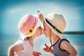 Babygirl and babyboy kissing on the beach