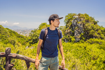 Man tourist on the background of Beautiful Marble mountains and Da Nang, Vietnam