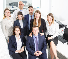 Portrait of glad successful professional business team in modern office