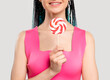 © golubovy - Z generation woman with braids lollipop candy. Happy carefree lady in pink top with creative ethnic hairstyle smiling isolated on white. Childish lifestyle. Fun leisure.