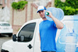 © AS Photo Family - Delivery man in front cargo van delivering bottles of water.