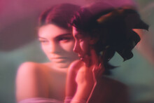 Fantasy Portrait. Feminine Elegance. Sensual Woman Face Blur Silhouette In Neon Red Light Double Exposure Noise Effect. Mindfulness Tranquility. Dreamlike Contemplation.
