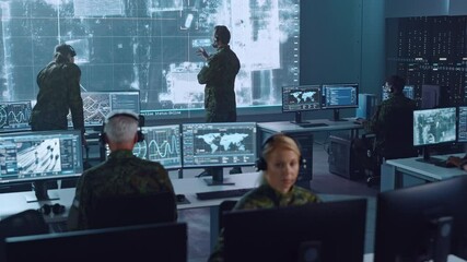 Fototapete - Military Surveillance Team of Officers Locked a Target on a Vehicle from a Satellite and Monitor it on a Big Display in Office for Cyber Operations for Managing Security and Army Communications. 