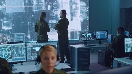 Fototapete - Military Surveillance Team of Officers Locked a Target on a Vehicle from a Satellite and Monitor it on a Big Display in Office for Cyber Operations for Managing Security and Army Communications. 