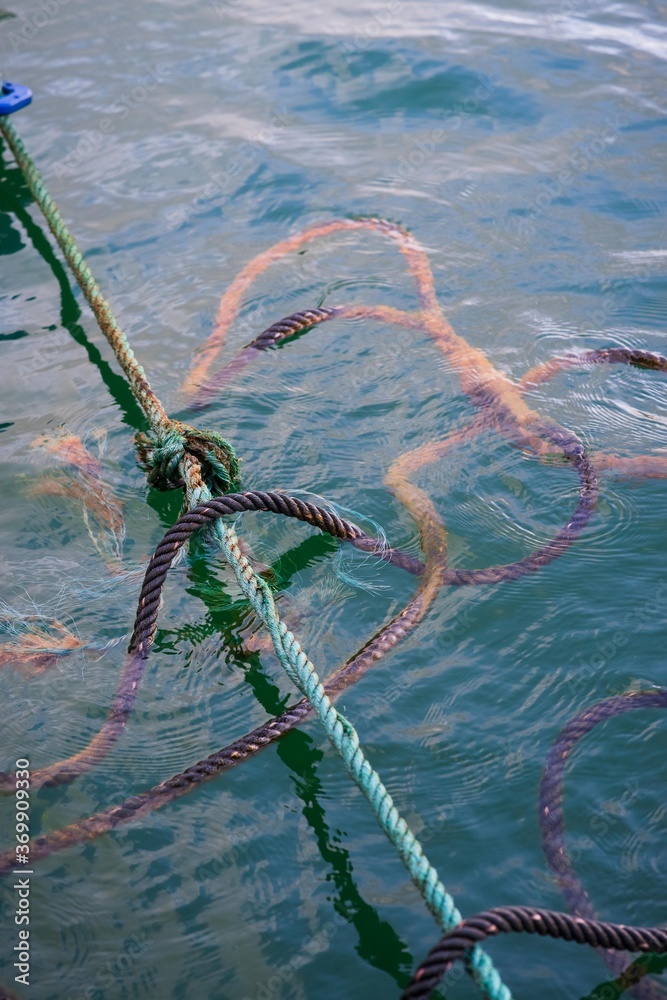 Rope above the surface of the deep green lake water background. Stock ...
