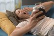 © StockPhotoPro - Woman waking up and holding the alarm clock