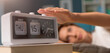 © StockPhotoPro - Woman waking up and turning off the alarm
