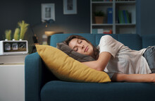 Relaxed Woman Sleeping On The Sofa At Home