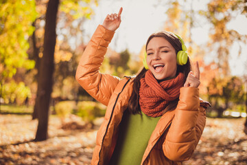 Sticker - Can not be bothered. Photo of pretty careless dreamy lady smiling close eyes listen music fingers up dancing autumn park wear headphones scarf green turtleneck orange windbreaker outside