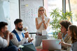 © luckybusiness - Young woman leading business meeting