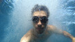 man in bubbles deep underwater