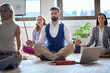 Leinwandbild Motiv Meditating in the office; Mindfullness in the office concept