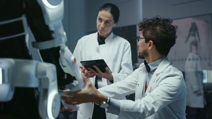 Aufkleber - In Robotics Development Laboratory: Chief Female Engineer and Top Male Scientist Work on a Bionics Exoskeleton Prototype. Designing Powered Exosuit to Help Disabled People, Hard Labor Workers