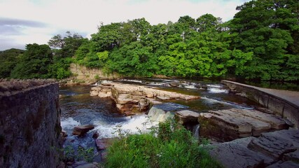 Wall Mural - A scenic view of the cascading waterfalls of the River Swale at Richmond,North Yorkshire,England, UK