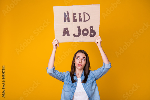 Need a job. Photo of pretty loser business lady carton placard above head jobless poor money asking help support assistance wear casual denim shirt isolated bright yellow color background