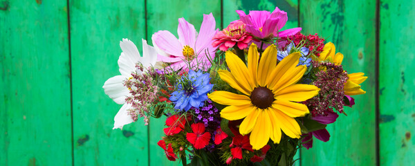 bouquet of colorful wild flowers with sunflowers and cosmos flowers - summer background and greeting