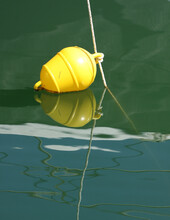 Yellow Buoy Afloat On The Water