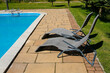 sunbeds next to the garden swimming pool