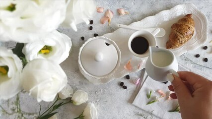 Wall Mural - Pouring milk into coffee cup top view