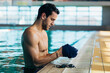 © Lumina/Stocksy - Swimmer Putting on Swimming Cap