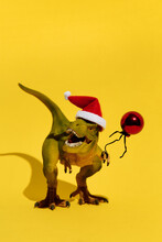 Dinosaur In Christmas Hat With Red Balloon