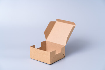 Wall Mural - Brown paper box for food package. carton on a gray background.