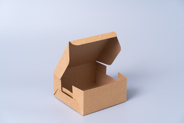 Wall Mural - Brown paper box for food package. carton on a gray background.