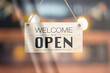 © Maderla - Text on vintage black sign 'Come in we're open' in  cafe and restaurant.