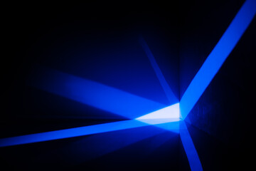 Leinwandbilder - Abstract background with blue rays of light on the wall