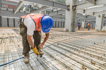 Construction Worker Tightening The Iron Mesh Rods To Steel Plates
Galvanized Steel Flooring In A Big Construction Site
