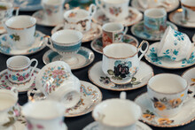 Closeup Retro Porcelain Cups On Countertop In Sunday Flea Market. Details From Antique Bazaar.