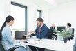 © focusandblur - Business people discussing work using laptop at office meeting