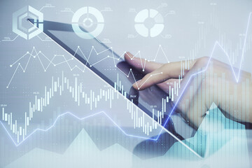 Multi exposure of man's hands holding and using a digital phone and forex graph drawing. Financial market concept.