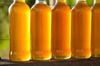 Colorful bottles of honey with a green background.