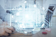 © peshkova - Social network theme hologram with businessman working on computer on background. Concept of world wide web. Multi exposure.