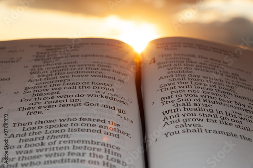 Fotografía Holy Bible open at sunset with highlight on Malachi 4:2