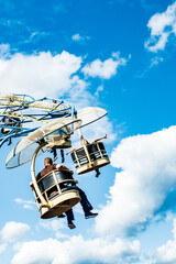 Wall Mural - Ride carousel in motion in amusement park at sunny day