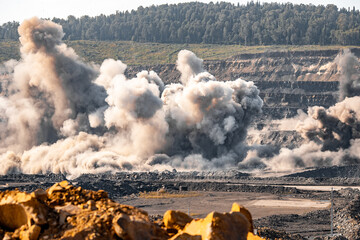 Canvas Print - Explosive works on open pit coal mine industry with dust and puffs of smoke