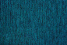 Abstract Solid Background Made Of Dark Fashionable Blue-turquoise Fabric With Black Speckles.