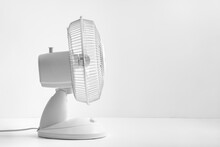 White Desktop Electric Fan. Escape From The Hot Summer Heat. Cooling Of High Air Temperature. Minimal Style, Copy Space.