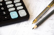 © Valiantsina - financing. calculator and pen heals on a financial chart