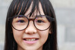 An Asian girl is wearing glasses. Short sight in an  children girl.
