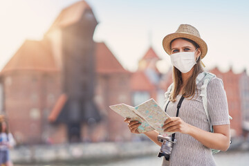 Wall Mural - Female tourist wearing a mask sightseeing Gdansk Poland in summer