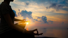 The Silhouette Of Woman Sitting Yoga Alone,Relax And Meditate,mental Health Concept With Nature Spiritual.