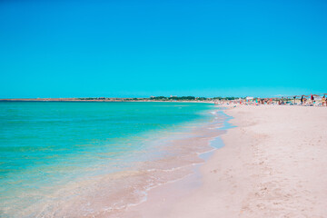 Wall Mural - Idyllic tropical beach with white sand, turquoise ocean water and beautiful colorful sky