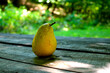 Fresh yellow pear on wooden surface with grunge texture, close up