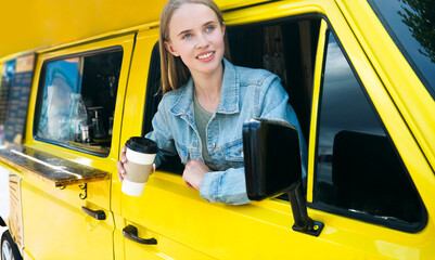 cafe in the car. caucasian girl with coffee cup. take it easy. happy woman client. cheerful female customer. small business idea. startup. store on wheels. Take with you. yellow van.