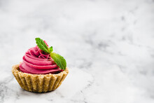 Mini Pink Cheesecake With Swirl Cream And Green Mint Garnish-background