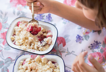 Wall Mural - Girl holding apple and blackberry compote crumble