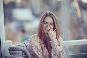 Wall Mural - happy girl autumn cafe sweater concept vision model with glasses posing